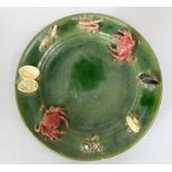 A Portuguese relief moulded charger in the Palissy manner with applied crabs and mussels on a