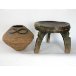 Tribal interest - a three legged circular stool together with a further bulbous pot