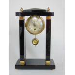 Attractive polished black slate and brass portico mantle clock, the single train 7 cm silvered