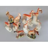 A collection of 19th century Staffordshire models of greyhounds comprising two pairs of standing