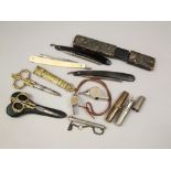 A 19th century scissors in brass with casework, another pair, two cut throat razors, two pocket tool