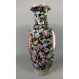 A large oriental vase of baluster shaped form with polychrome painted dragon and floral decoration