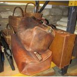 Two vintage leather Gladstone type bags with brass fittings, a further tan leather suitcase, a cased