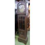 An early 20th century oak longcase clock, with arched hood, circular silvered dial, two train