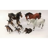 A collection of Beswick model horses comprising a matt glazed trotting brown horse, a standing