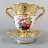 A 19th century Derby two handled goblet raised on an integral stand, with painted floral sprays