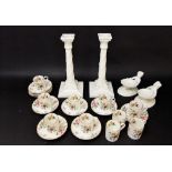 A pair of Royal Worcester white glazed candlesticks in the classical manner with rams head and