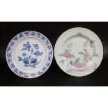 A 18th century tin glazed earthenware plate with painted chinoiserie style rock peony and insect