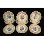 A good quality Victorian dessert service with well painted botanical sprays within a yellow and gilt