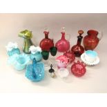 A mixed collection of coloured glassware to include two cranberry glass lidded ewers, various