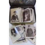 A metal biscuit box containing a large quantity of black and white royal commemorative postcards