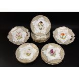 A collection of mid 19th century dessert wares with painted botanical sprays within grey and gilt