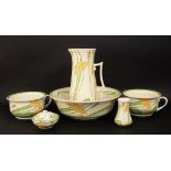 An early 20th century Minton's jug and basin set with stylised floral decoration in tones of green