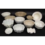 An interesting collection of 19th century jelly moulds including example of shaped form modelled