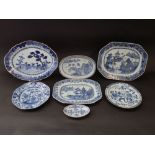 A collection of late 18th and early 19th century oriental blue and white serving plates and dishes