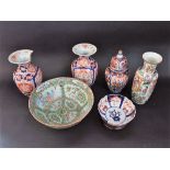 A collection of oriental ceramics including a pair of Imari vases, an Imari vase and cover, a