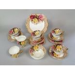 A collection of Stanley bone china tea wares with red and yellow rose decoration comprising milk
