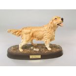 A Beswick matt glazed model of a golden retriever raised on an oval base