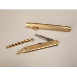 Three 9ct items to include an engine turned pencil, pocket knife and manicure tool (3)