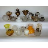 A collection of vintage oil lamps and shades