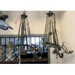 A pair of cast brass hanging ceiling lights with verdigree finish, six fixed rods supporting a