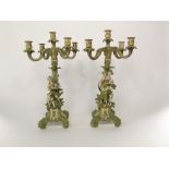 A pair of large continental four branch candelabra with applied figures of a male bagpiper with