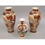 A pair of Satsuma baluster vases with typical decoration of figures and gilt highlights together