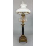 A good quality 19th century oil lamp with clear cut glass reservoir and faceted black column upon