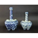 Two oriental blue and white flower holders with bulbous bodies and drawn necks with painted prunus