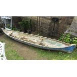 A dug out wooden canoe with weathered blue painted finish, 350cm long approx