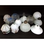 A collection of various antique and later glass shades to include ceiling lights, oil lamp shades,