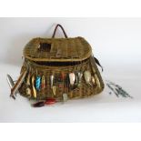 A good wicker fishing bag containing a number of lures and hooks, etc