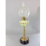 Late 19th century brass oil lamp, with opaline glass reservoir over painted with floral sprays