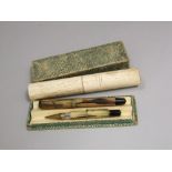 A 19th century bonework cylinder with pierced ends, cased fountain pen and propelling pencil