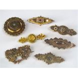 A collection of Victorian gold brooches; mostly 9ct with two 15ct examples including one of Etruscan