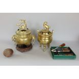 Two Chinese polished brass censers, each mounted with a dog of fo, a collection of Hamlet