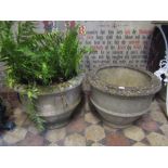 A pair of good quality weathered cast composition stone garden planters of squat circular form