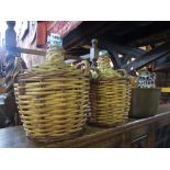 A good Victorian brass jam pan with swing handle, a brass trivet and two wicker bound glass wine