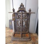 A cast iron umbrella/stick stand, probably Victorian, with decorative pierced trailing fruit and