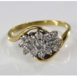 An 18ct diamond cluster ring of crossover style, size L, 3g