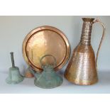 A large eastern copper ewer with planished finished together with a further patinated eastern copper