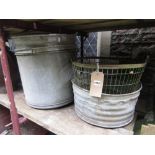 A large vintage galvanised bucket with loose loop handle, two further galvanised vessels/planters