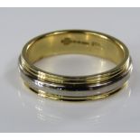 An 18ct yellow gold wedding ring with white gold banded decoration, size K/L, 5.5g