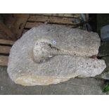 A weathered rough hewn stone shoot/mould of rounded and tapered form 66 cm long x 50 cm wide x 20 cm
