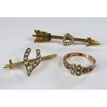 Three seed pearl set items comprising a 15ct Cupid's arrow bar brooch, a wishbone bar brooch in