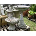 A weathered cast composition stone two sectional bird bath with foliate detail and shallow