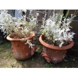 A pair of terracotta garden urns with simulated twig and combed bark effect, 45 cm diameter approx