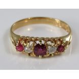 An 18ct pink ruby and diamond ring in claw setting, size O/P, 3.5g