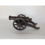 An antique cast iron scale model of a cannon, 36cm long