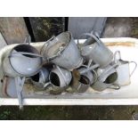 Six vintage galvanised watering cans of varying design and capacity, one other later example and two